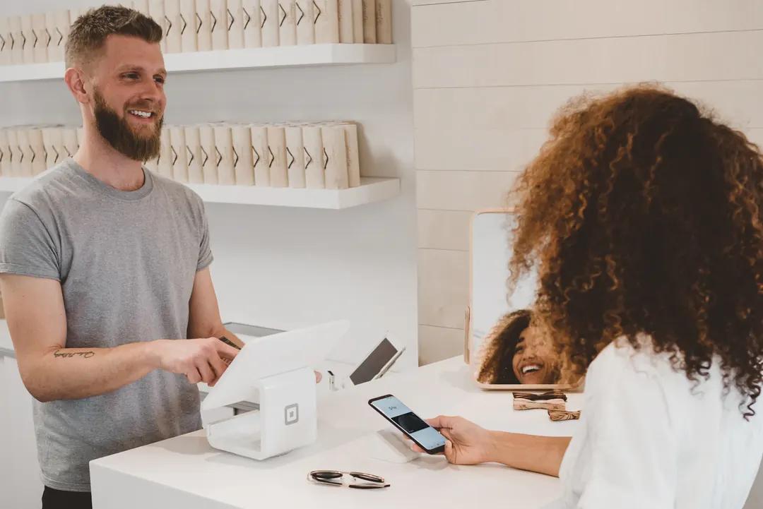 Customer making a contactless payment at a shop counter